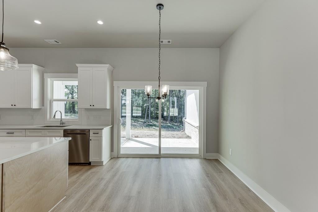 125 Rains Road Jefferson, GA 30549 - Photo 15 of 43 a kitchen with kitchen island a counter top a stove and cabinets