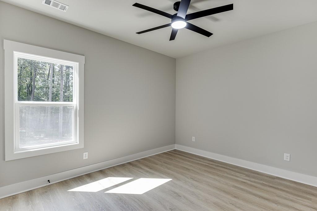 125 Rains Road Jefferson, GA 30549 - Photo 23 of 43 an empty room with a window and a fan
