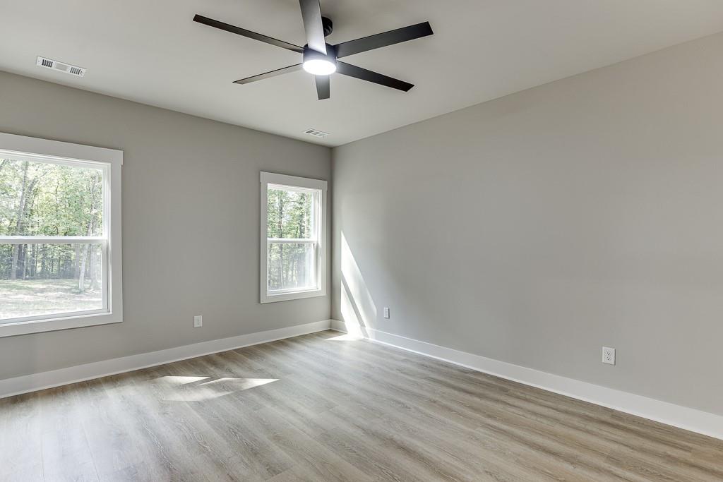 125 Rains Road Jefferson, GA 30549 - Photo 29 of 43 an empty room with wooden floor and windows