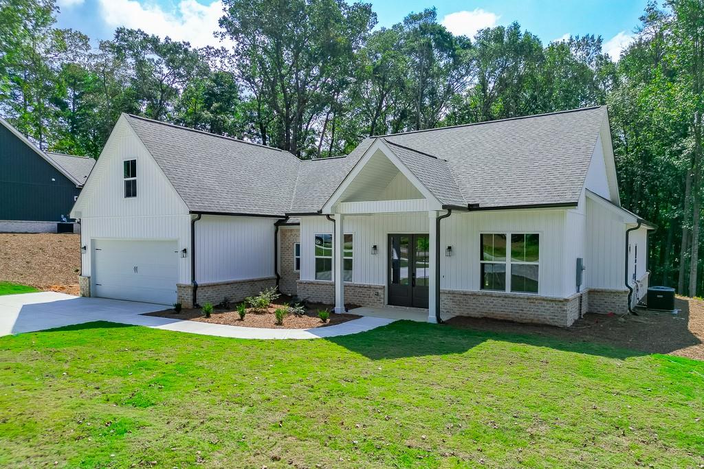 125 Rains Road Jefferson, GA 30549 - Photo 3 of 43 a front view of a house with garden