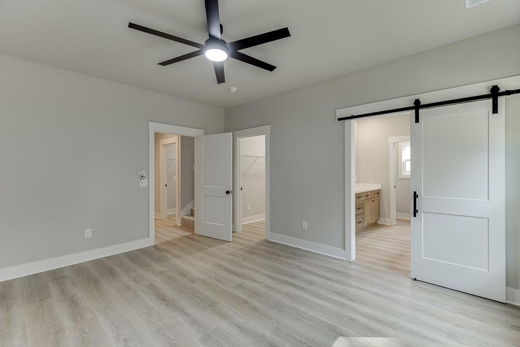 125 Rains Road Jefferson, GA 30549 - Photo 31 of 43 a view of an empty room with wooden floor a ceiling fan and windows