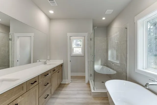 a bathroom with a tub and shower
