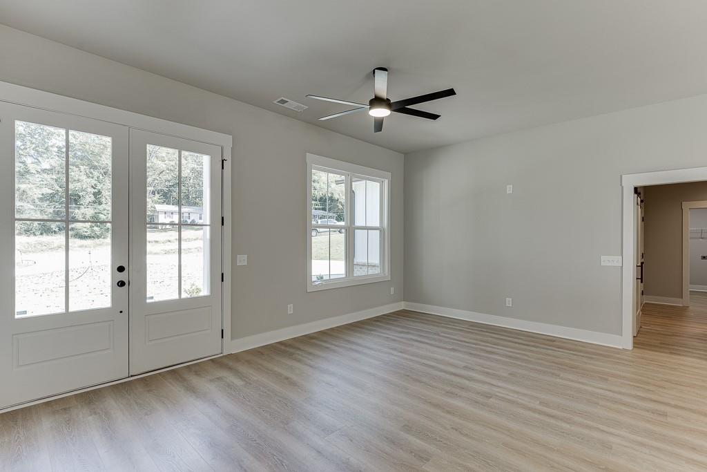 125 Rains Road Jefferson, GA 30549 - Photo 7 of 43 a view of an empty room with wooden floor and a window