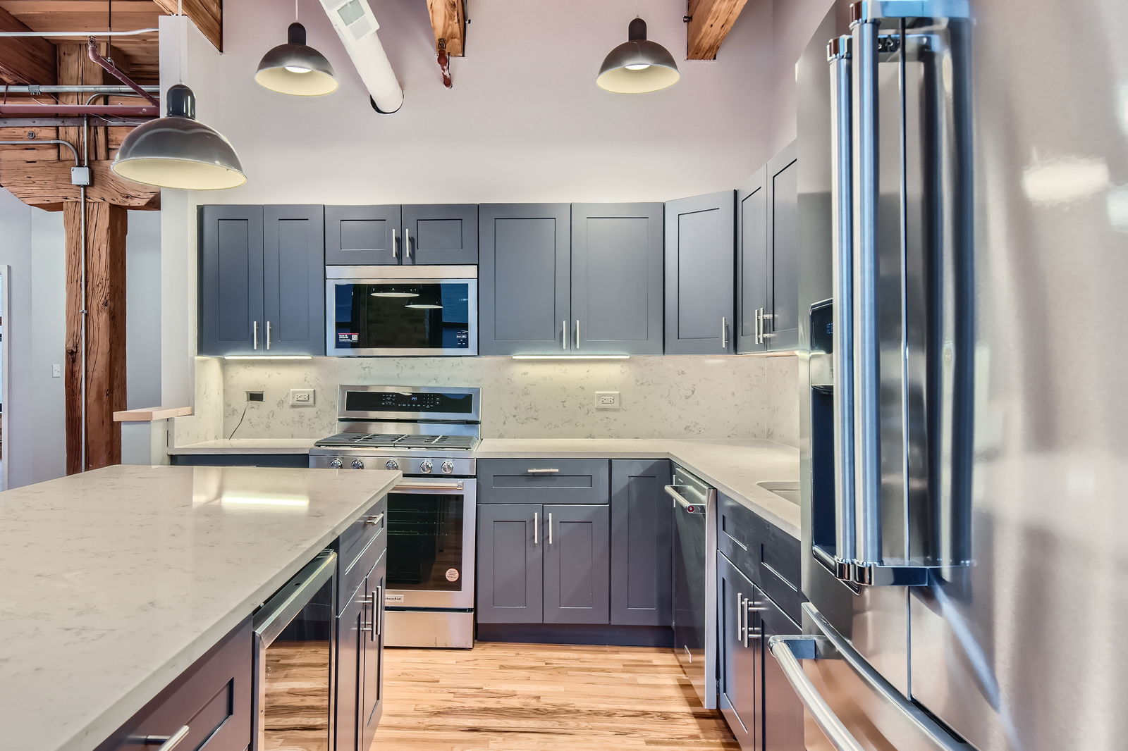 368 West Huron Street, Unit 2N Chicago, IL 60654 - Photo 13 of 28 a kitchen with kitchen island granite countertop a stove top oven a sink and dishwasher