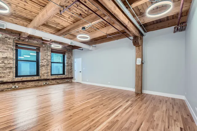 a view of a hall with wooden floors
