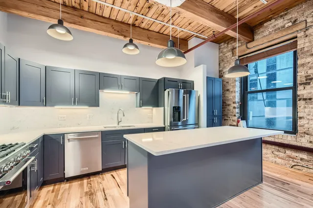 a kitchen with granite countertop a stove and a microwave