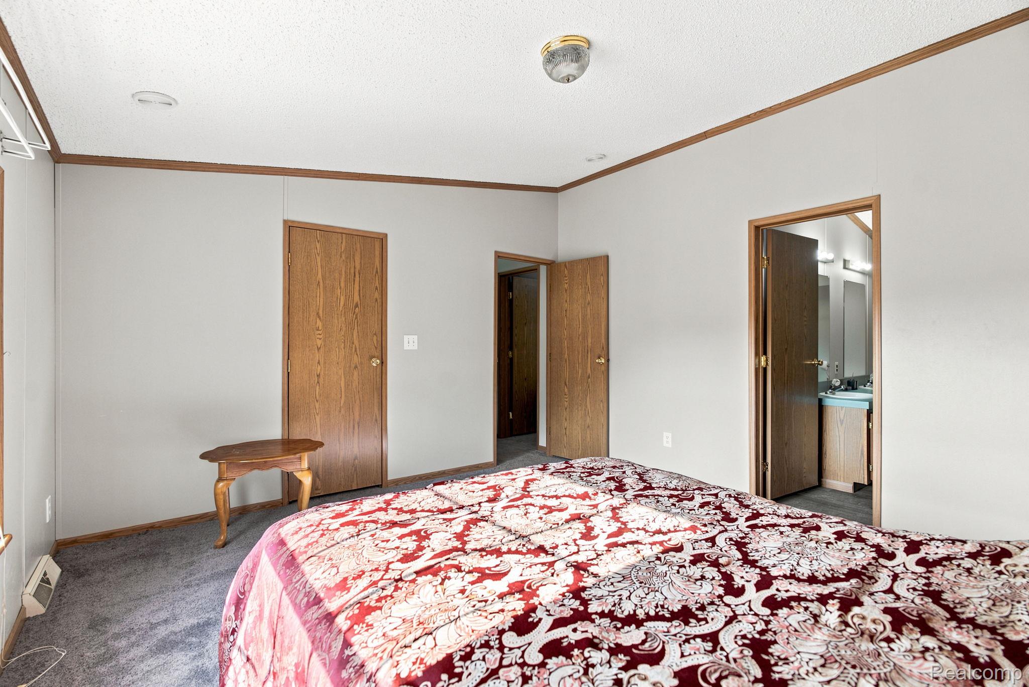 2390 Lakeshore Road Applegate, MI 48401 - Photo 66 of 97 Wood-finish trim accents, textured ceiling, recessed lighting, and wall-mounted light fixture