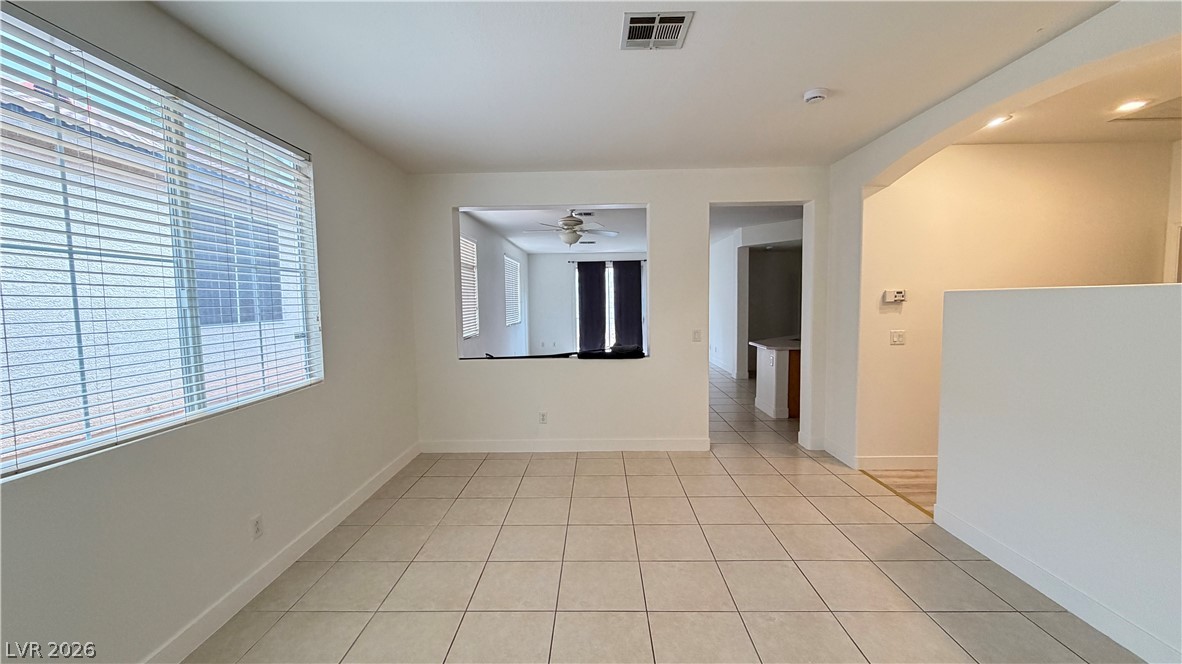 Tiled flooring and large windows bring classic character to this versatile living area.