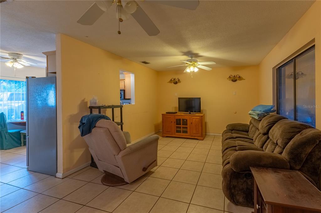 9349 Edison Road Lithia, FL 33547 - Photo 11 of 27 a living room with furniture and a chandelier