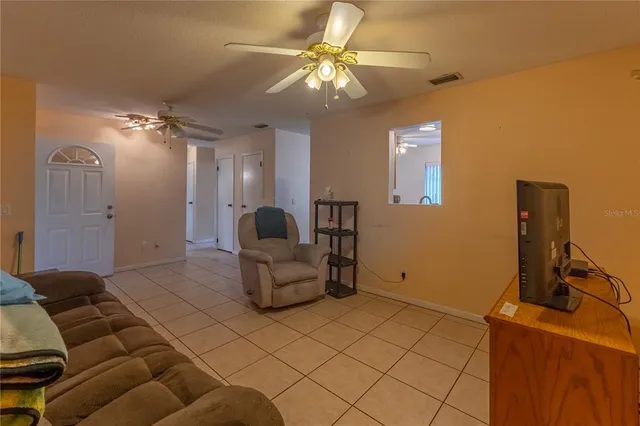 a kitchen with stainless steel appliances granite countertop a stove top oven a sink dishwasher and a refrigerator with wooden floor