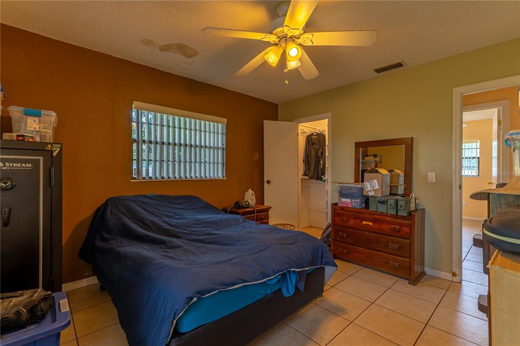 9349 Edison Road Lithia, FL 33547 - Photo 18 of 27 a bedroom with a bed and a chandelier