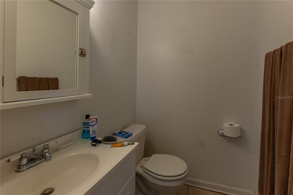 9349 Edison Road Lithia, FL 33547 - Photo 19 of 27 a bathroom with a sink a toilet and a mirror