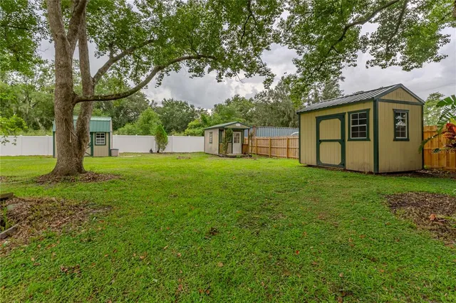 a view of a house with a backyard