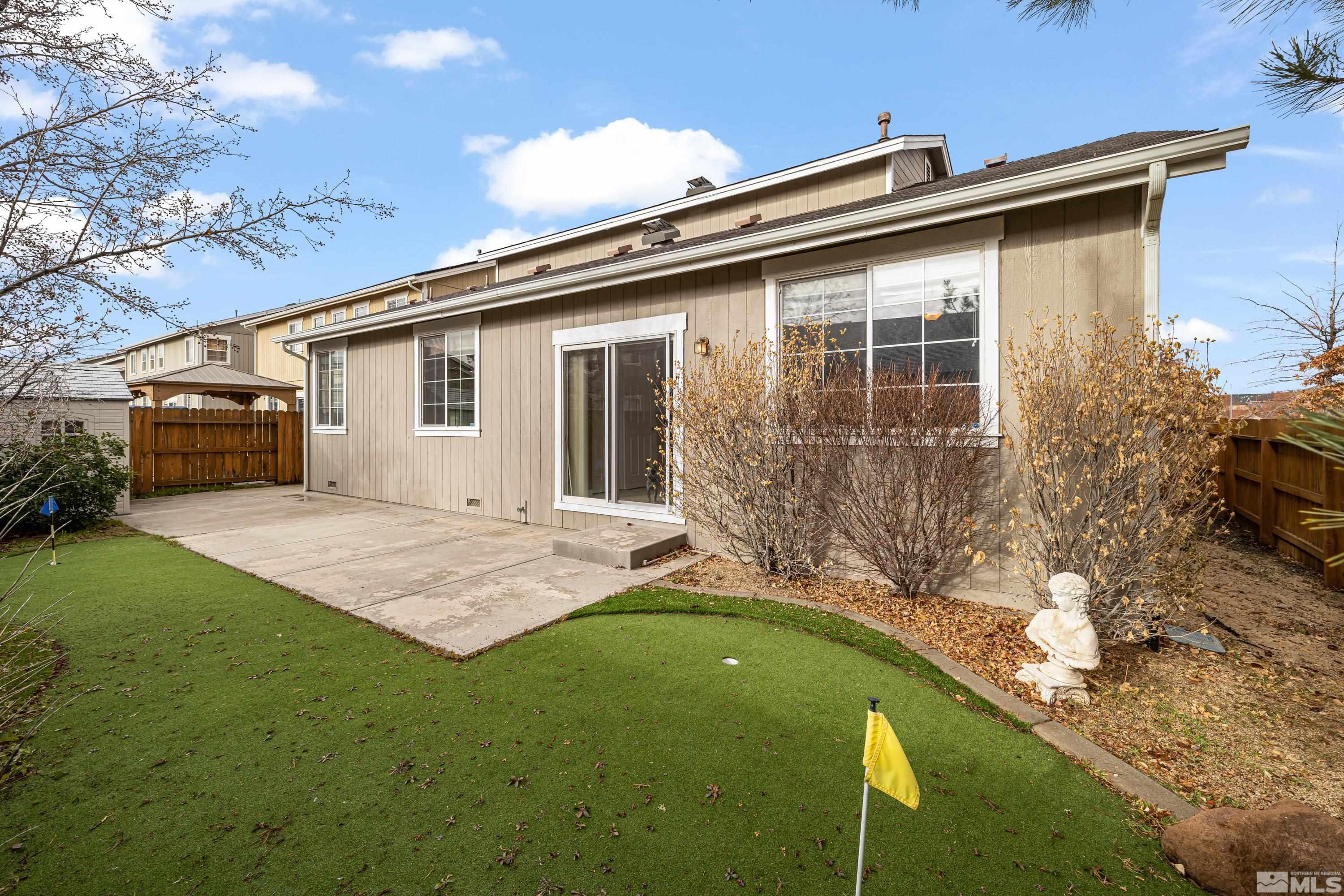 8900 Sorcha Street Reno, NV 89506 - Photo 14 of 39 a front view of a house with garden
