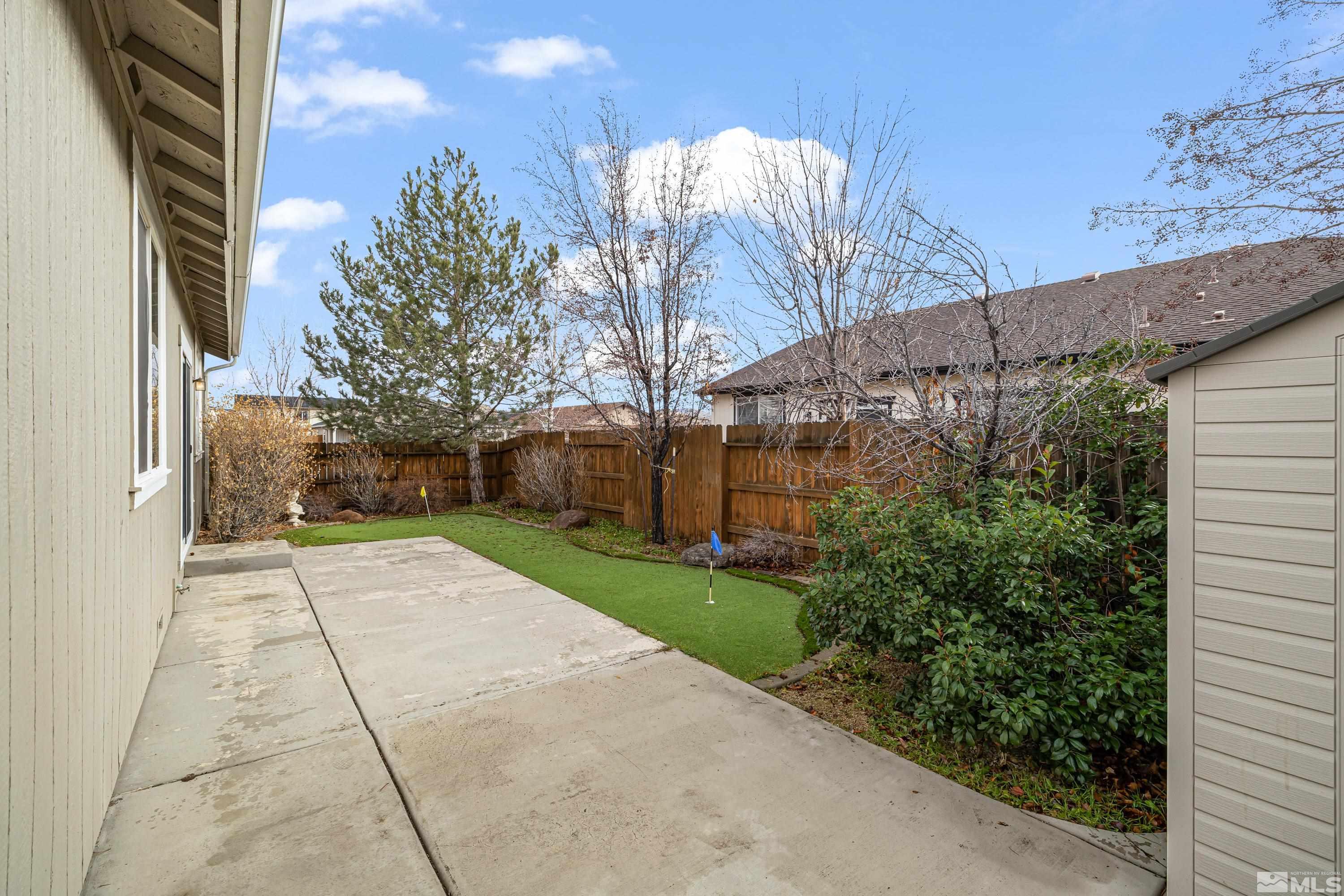 8900 Sorcha Street Reno, NV 89506 - Photo 15 of 39 a pathway of a house with a yard