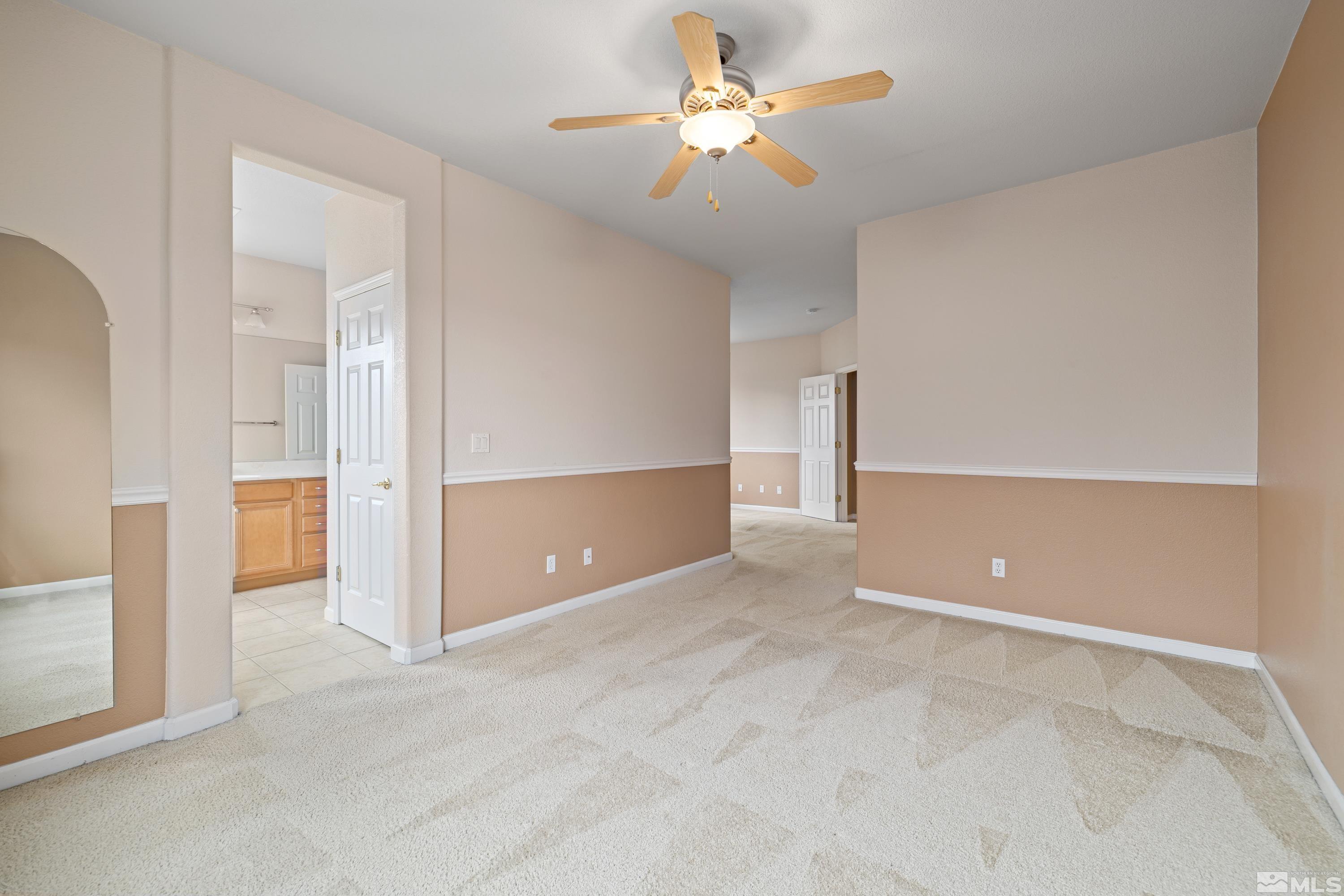 8900 Sorcha Street Reno, NV 89506 - Photo 20 of 39 an empty room with closet and a chandelier fan