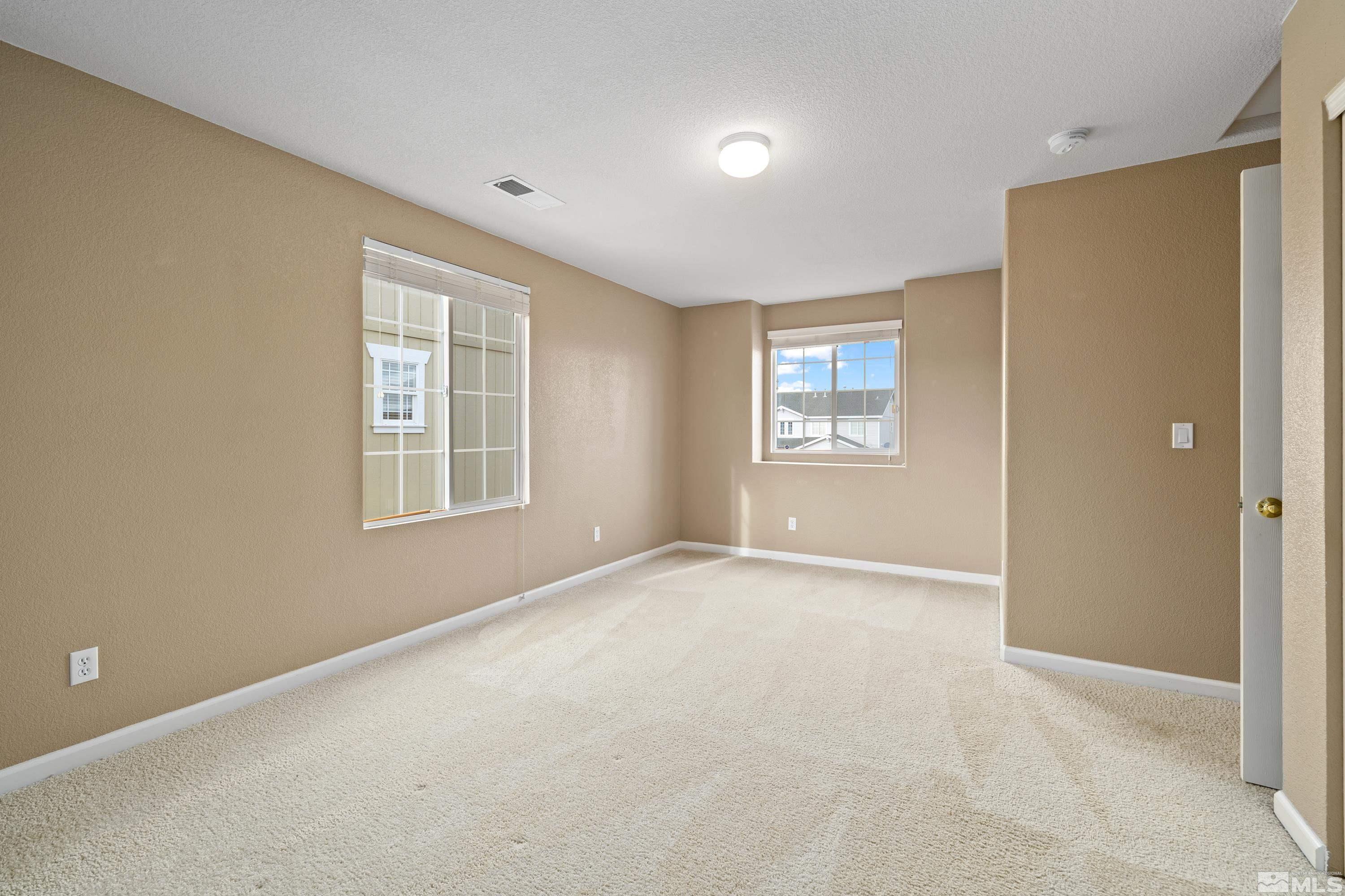 8900 Sorcha Street Reno, NV 89506 - Photo 24 of 39 an empty room with windows and closet