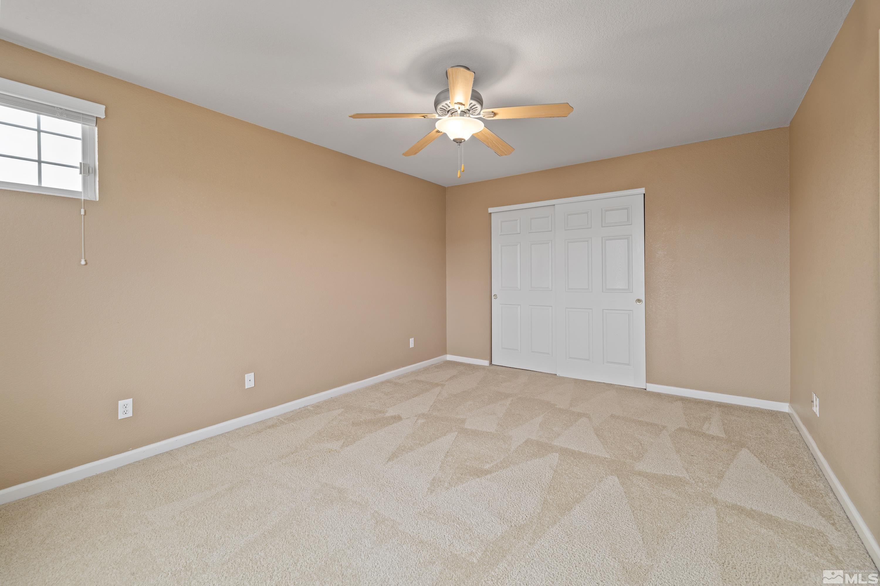 8900 Sorcha Street Reno, NV 89506 - Photo 28 of 39 a view of an empty room with chandelier fan and table