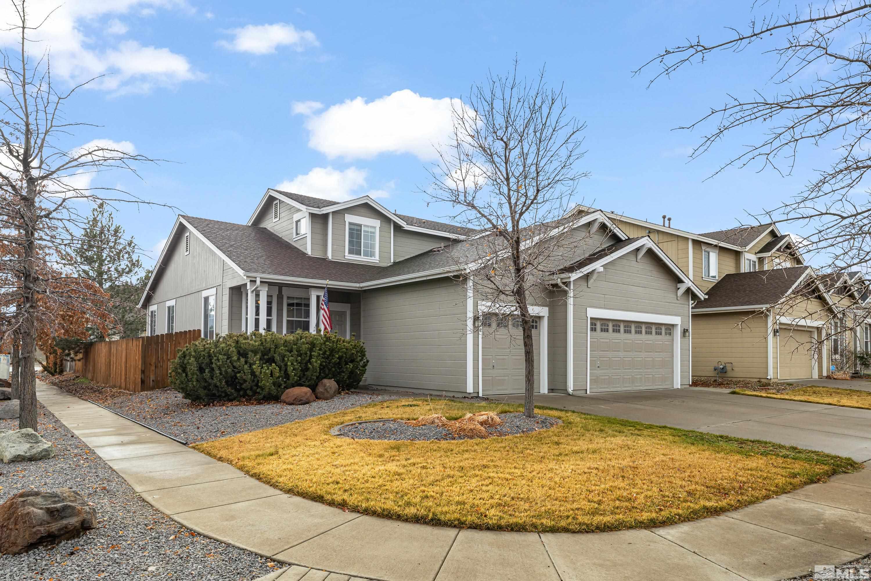 8900 Sorcha Street Reno, NV 89506 - Photo 35 of 39 a view of a white house with a small yard and large tree