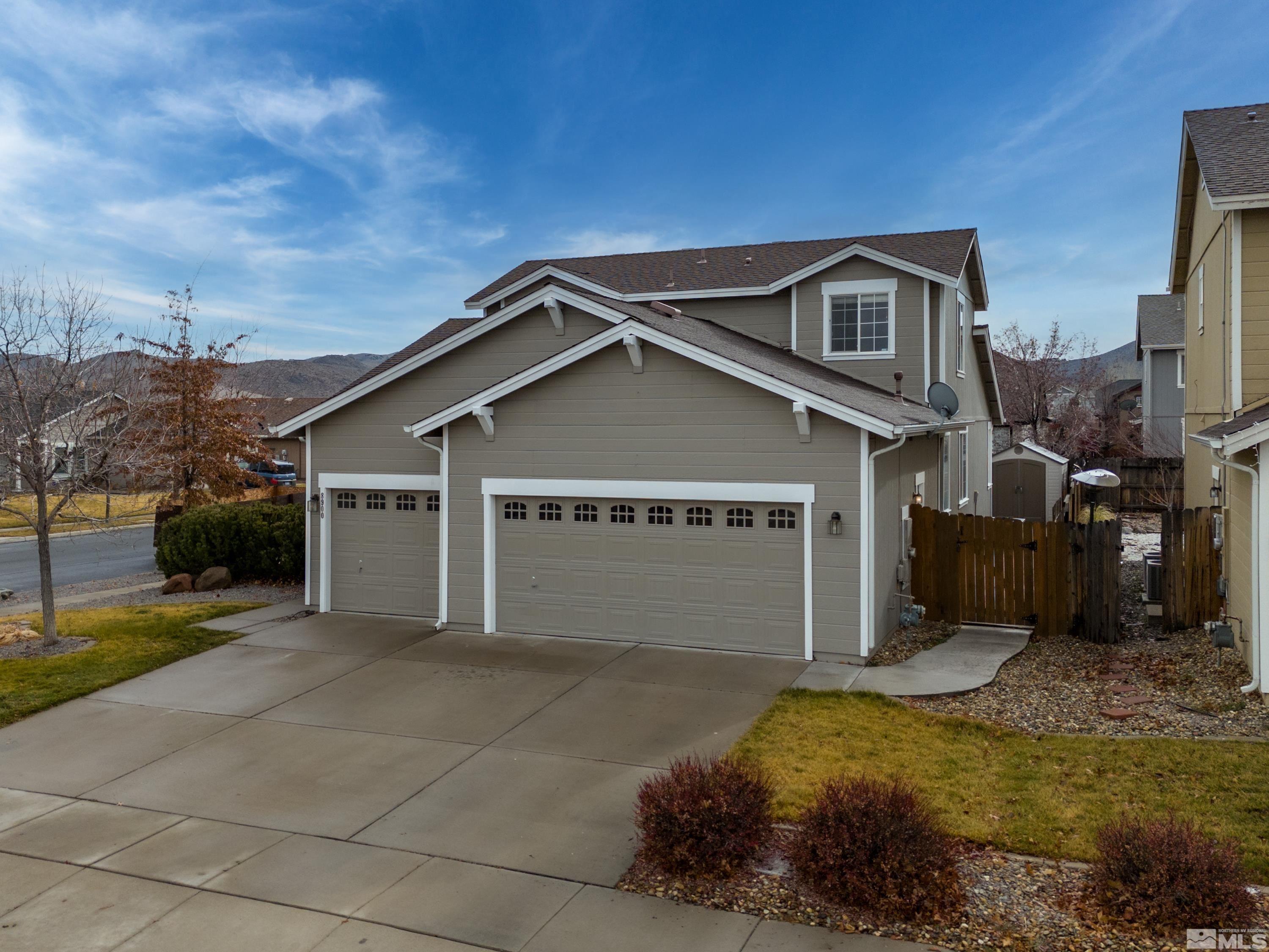 8900 Sorcha Street Reno, NV 89506 - Photo 38 of 39 a front view of a house with a yard and garage
