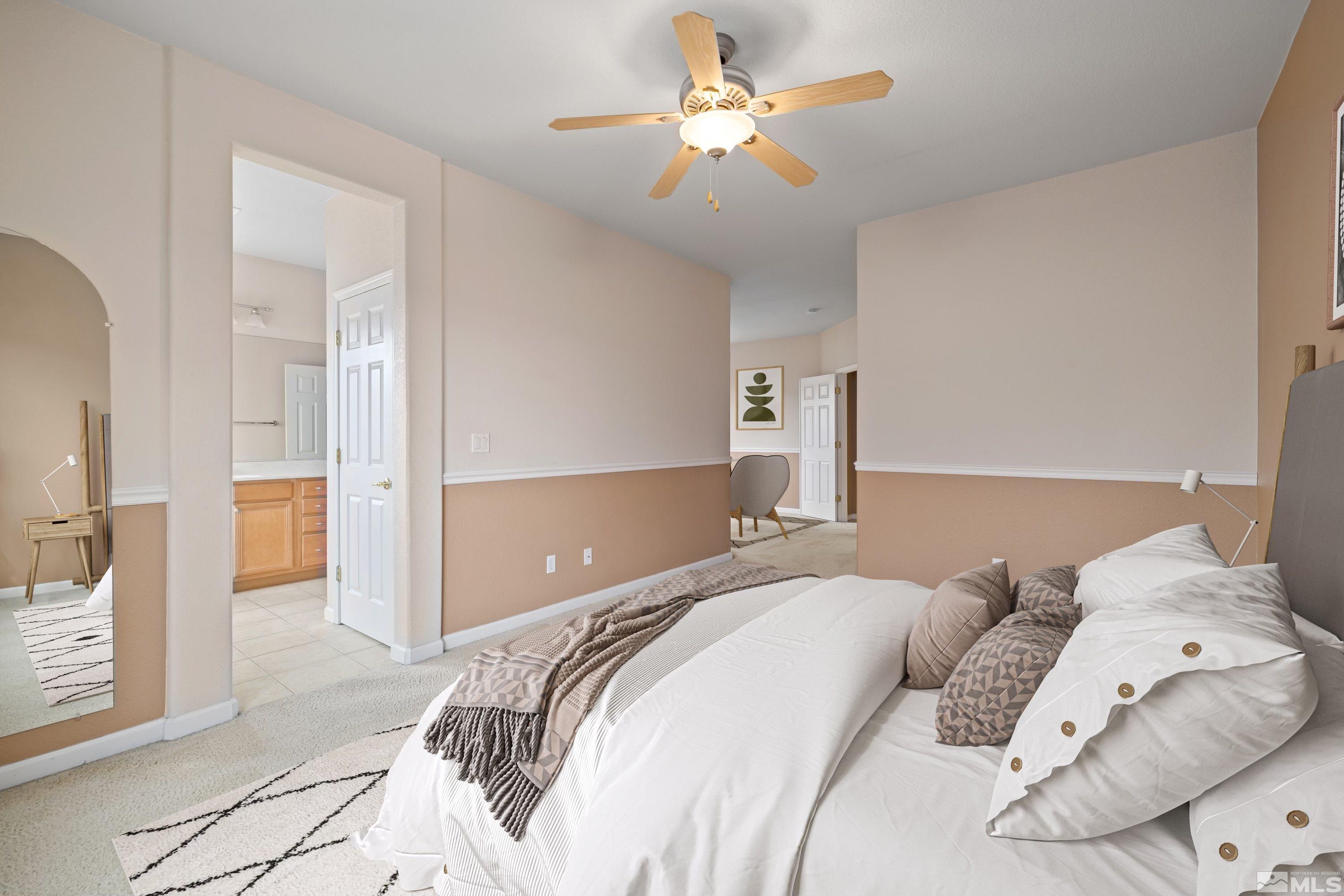 8900 Sorcha Street Reno, NV 89506 - Photo 8 of 39 a bedroom with a bed and a chandelier