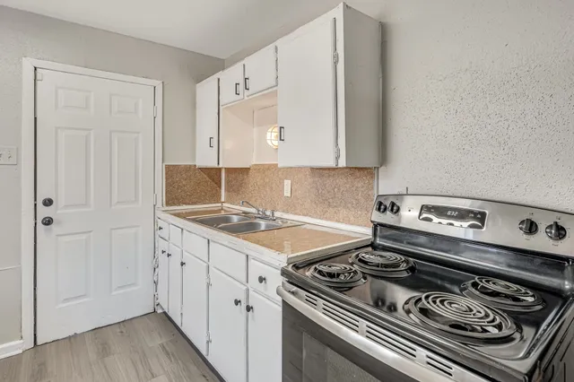 a kitchen with a stove and a refrigerator