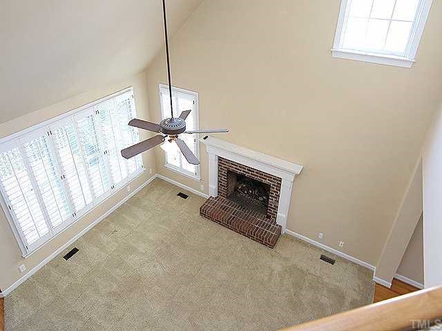 2936 Tillinghast Trail Raleigh, NC 27613 - Photo 5 of 12 a view of an empty room with a fireplace and a window