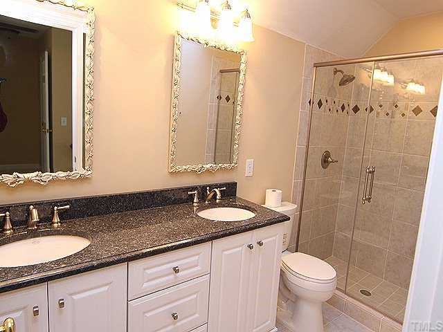 2936 Tillinghast Trail Raleigh, NC 27613 - Photo 10 of 12 a bathroom with a granite countertop sink toilet and shower