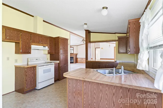 a kitchen with a sink stove and refrigerator