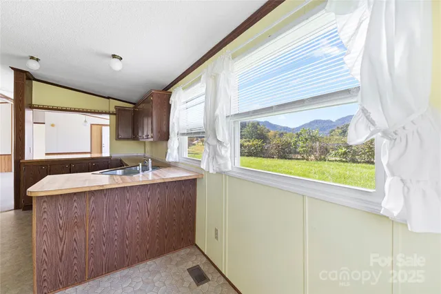 a large white kitchen with a large window