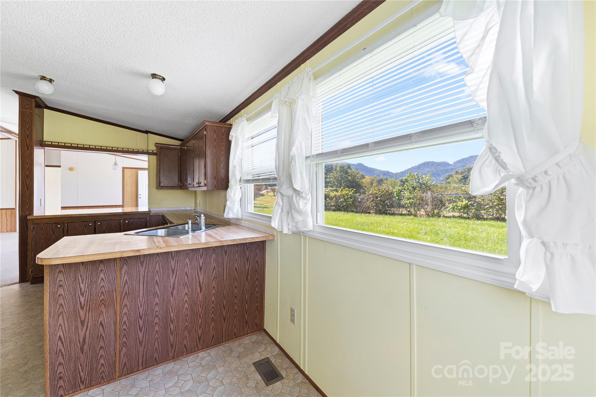 112 Melody Street Clyde, NC 28721 - Photo 18 of 47 a large white kitchen with a large window