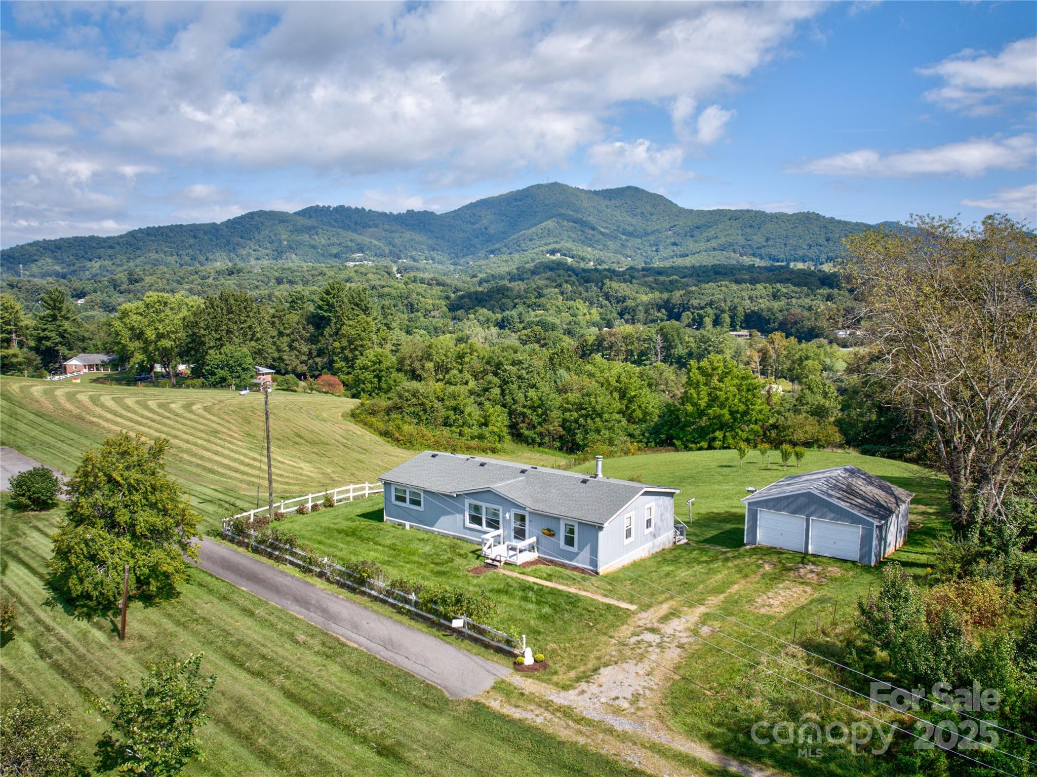 112 Melody Street Clyde, NC 28721 - Photo 2 of 47 a view of a garden with a lake