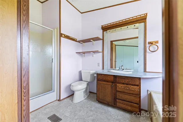 a bathroom with a toilet a sink and a mirror