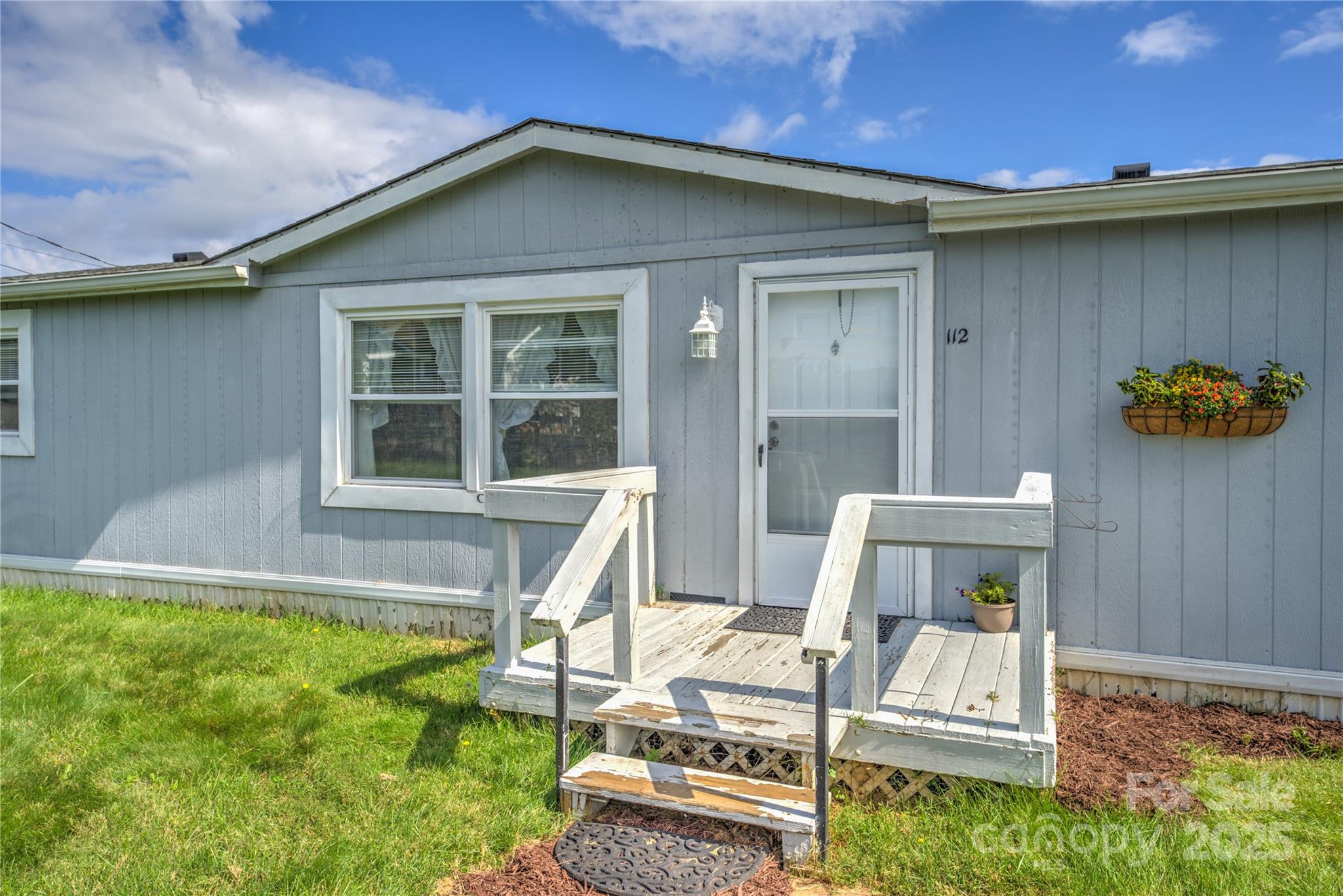 112 Melody Street Clyde, NC 28721 - Photo 3 of 47 a front view of a house with garden