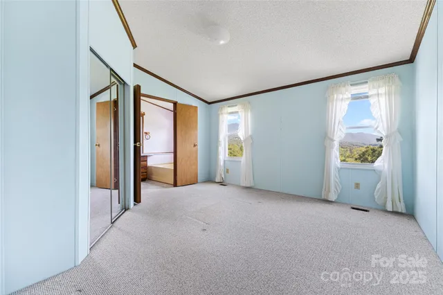 an empty room with windows and closet