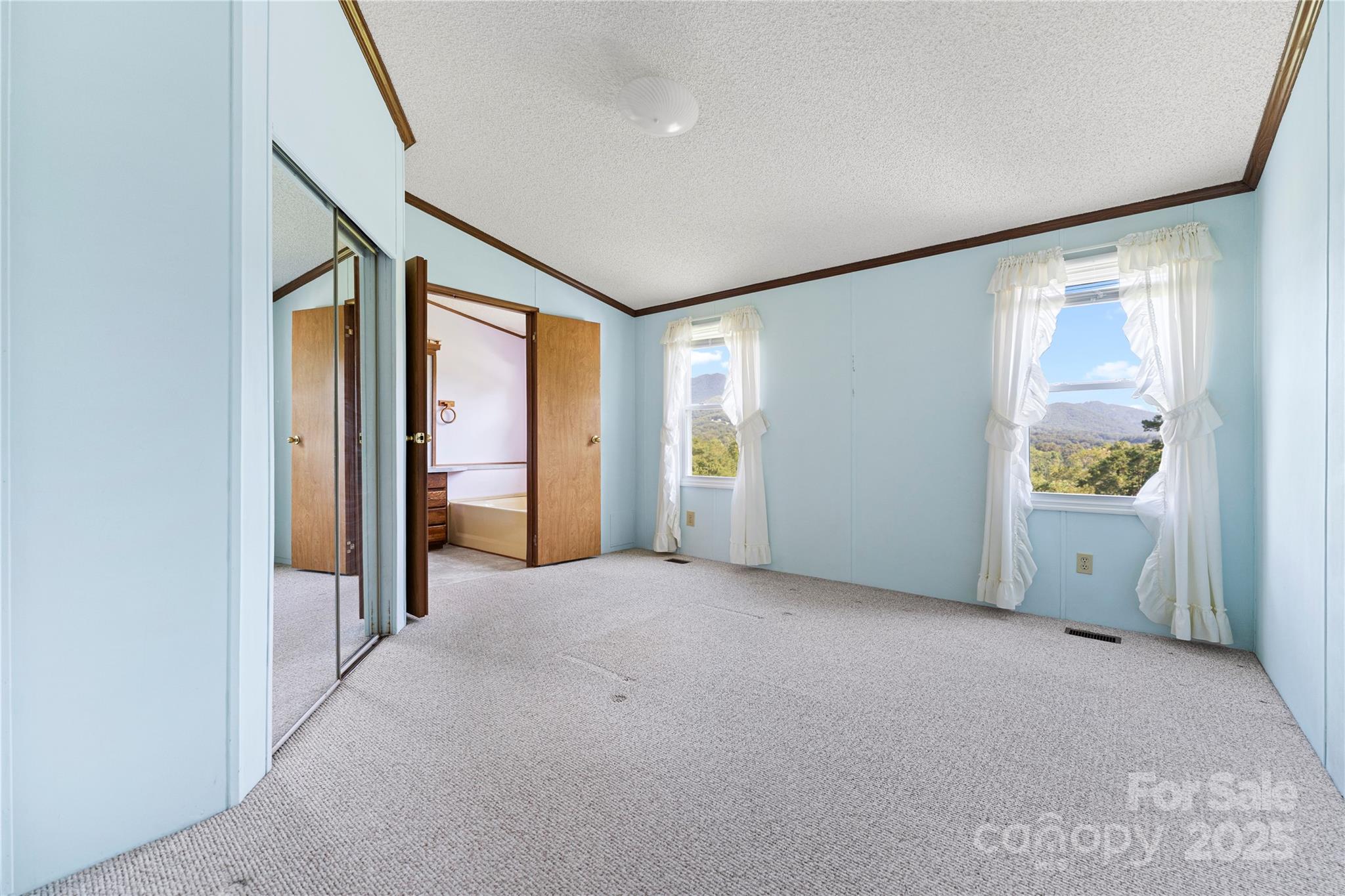 112 Melody Street Clyde, NC 28721 - Photo 31 of 47 an empty room with windows and closet