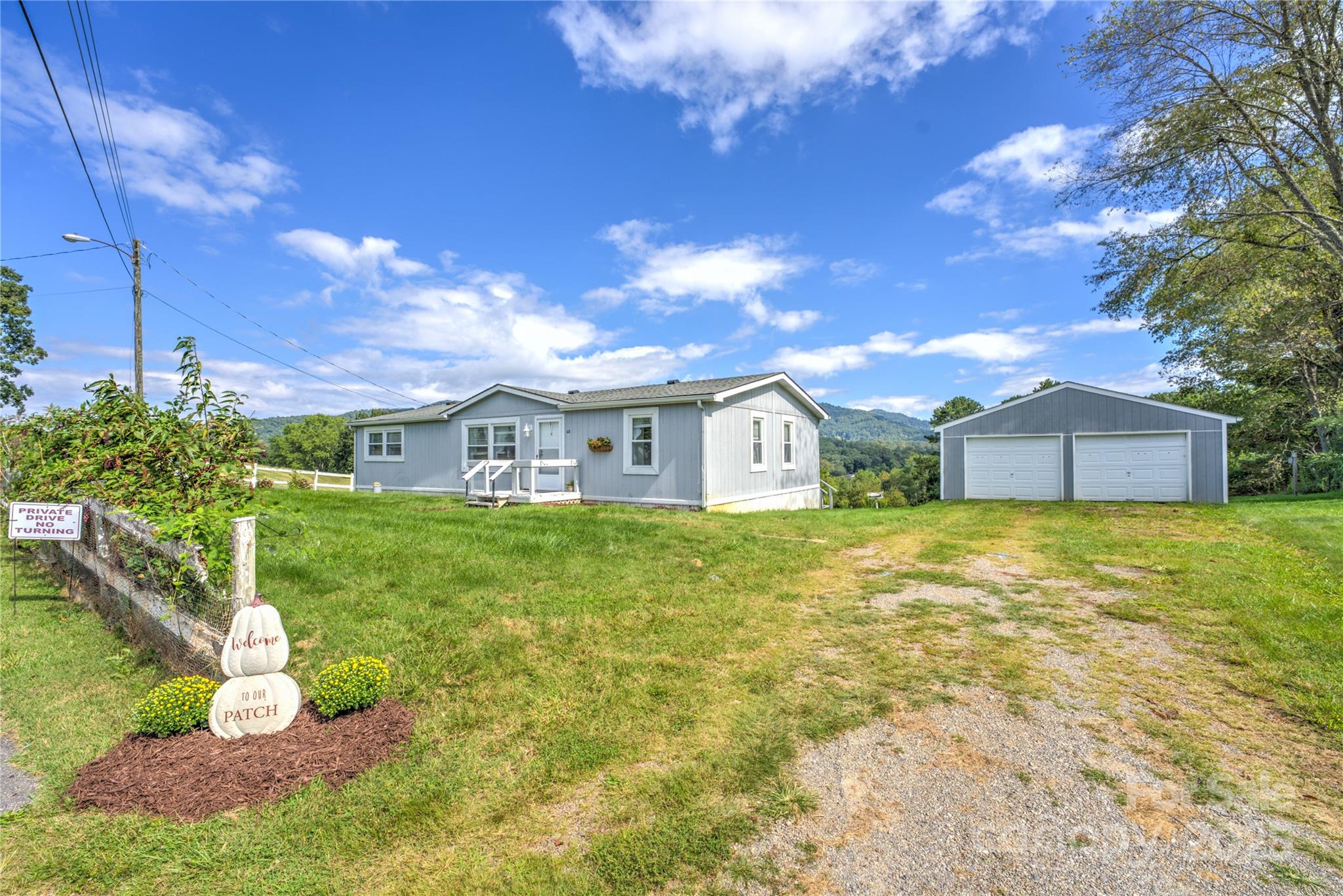 112 Melody Street Clyde, NC 28721 - Photo 35 of 47 a front view of a house with garden