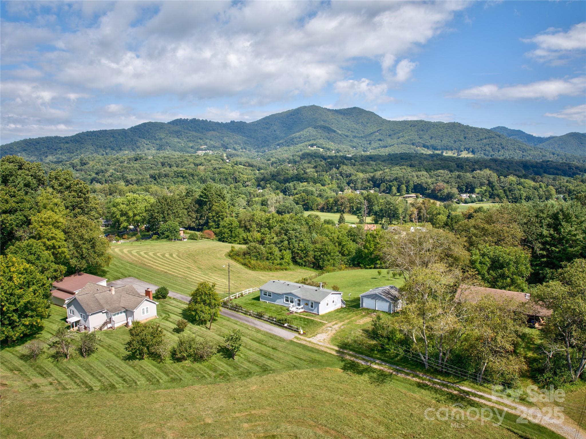 112 Melody Street Clyde, NC 28721 - Photo 36 of 47 a view of a lush green hillside and houses