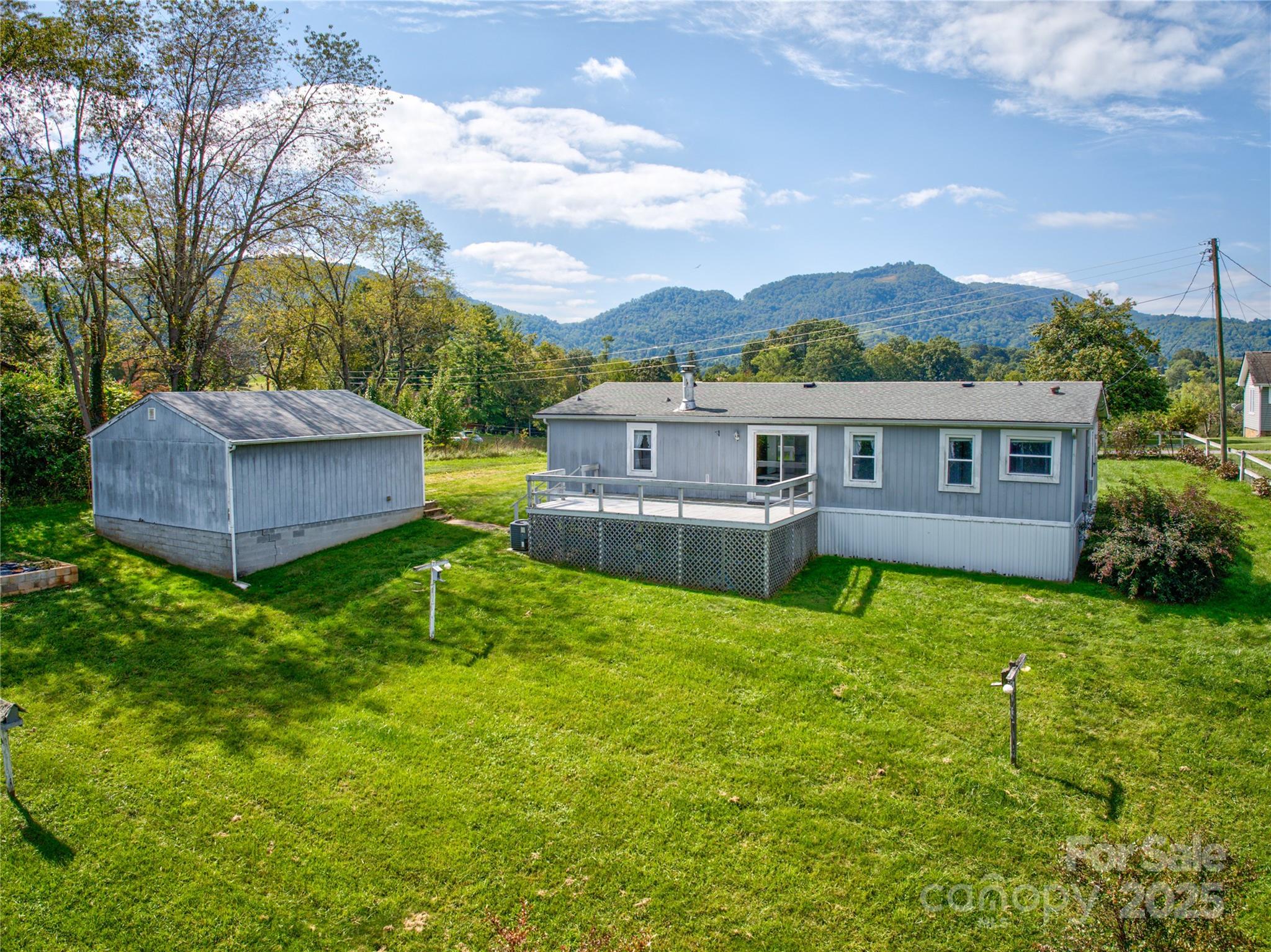112 Melody Street Clyde, NC 28721 - Photo 40 of 47 a view of house with a yard