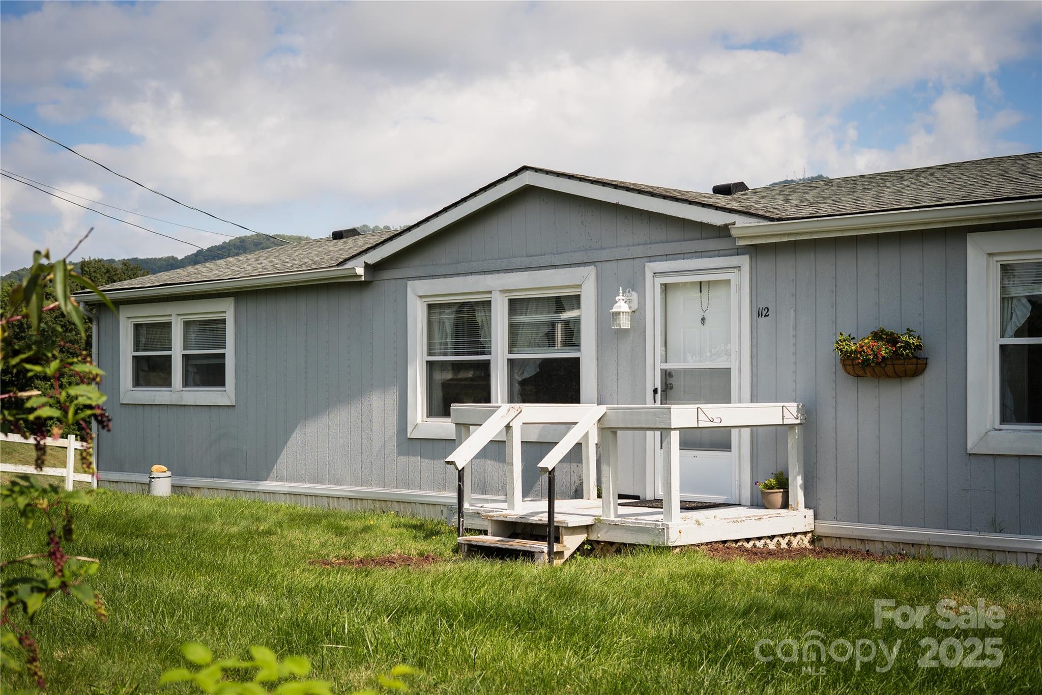 112 Melody Street Clyde, NC 28721 - Photo 4 of 47 a front view of a house with a yard fire pit and outdoor seating