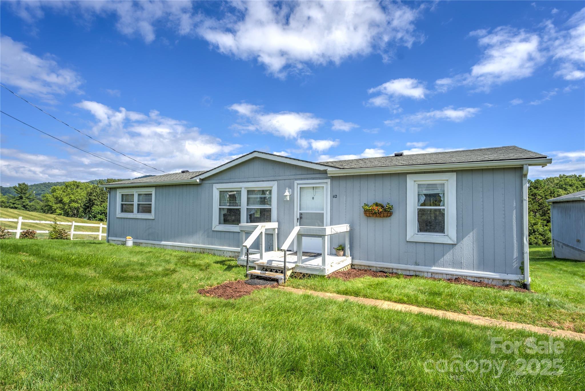 112 Melody Street Clyde, NC 28721 - Photo 42 of 47 a backyard of a house with table and chairs