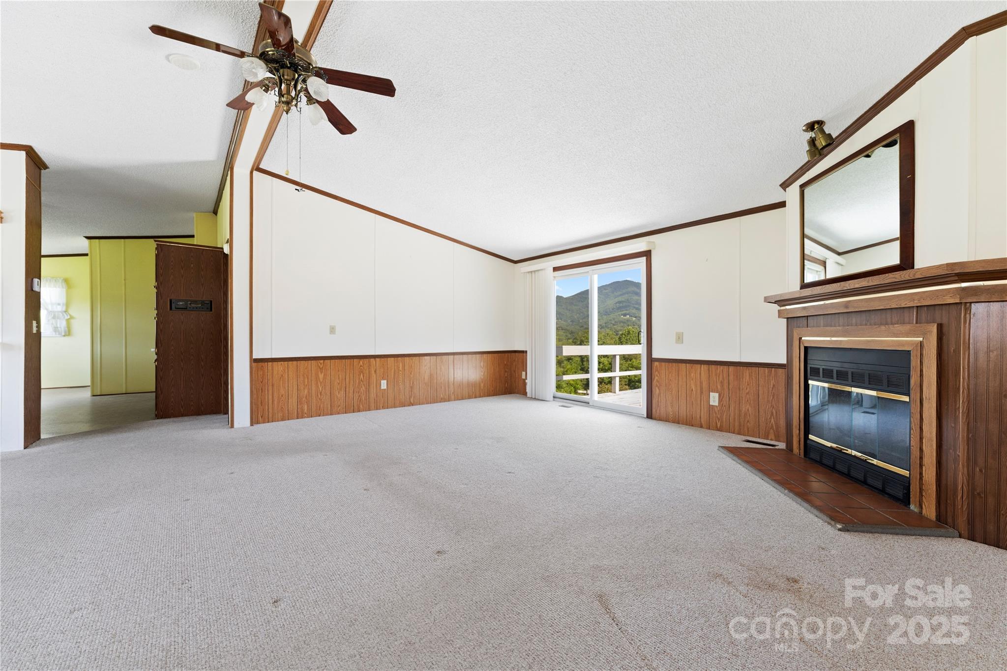 112 Melody Street Clyde, NC 28721 - Photo 8 of 47 a view of an empty room with a fireplace