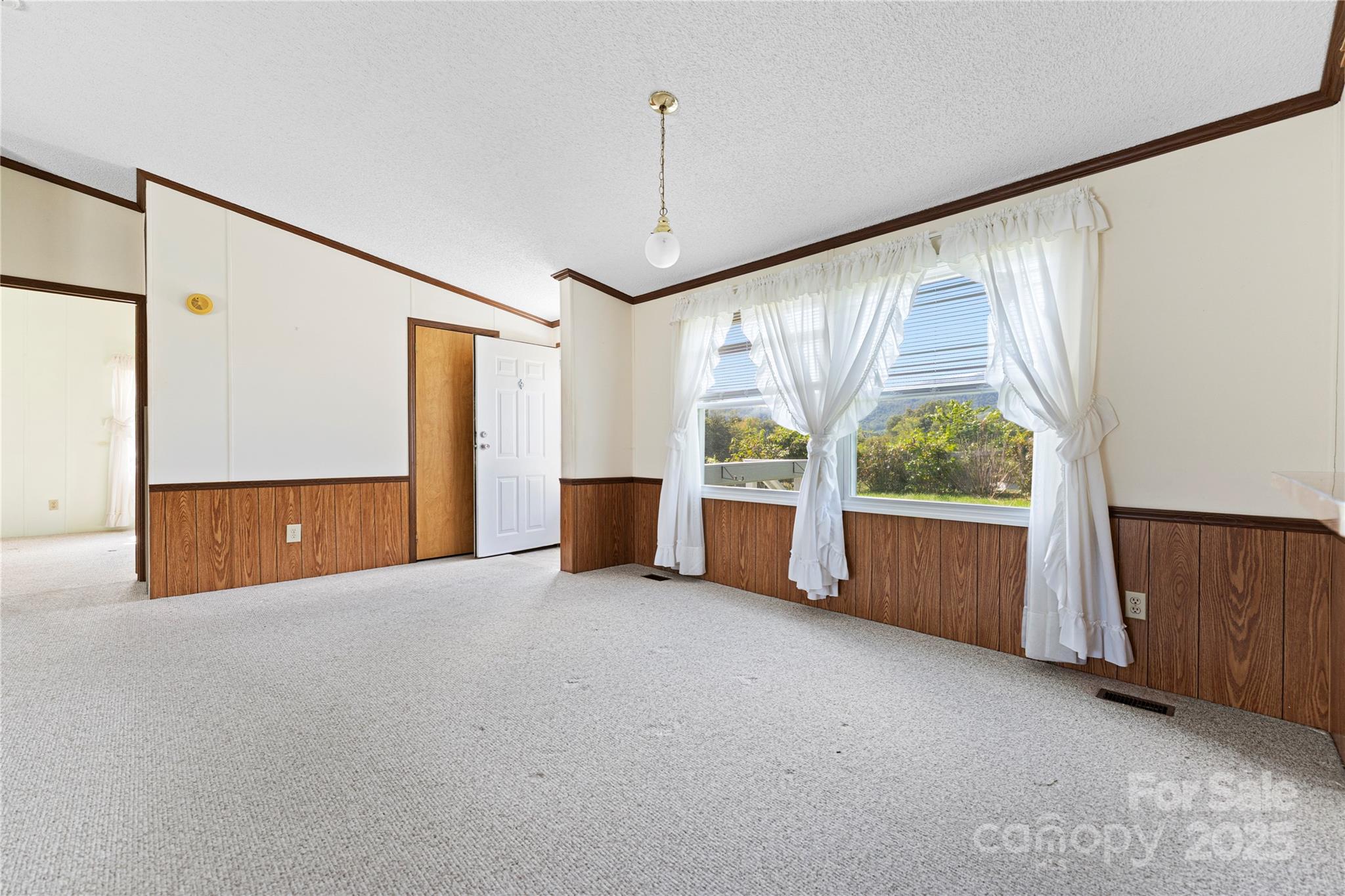 112 Melody Street Clyde, NC 28721 - Photo 10 of 47 a view of a room with furniture and a large window