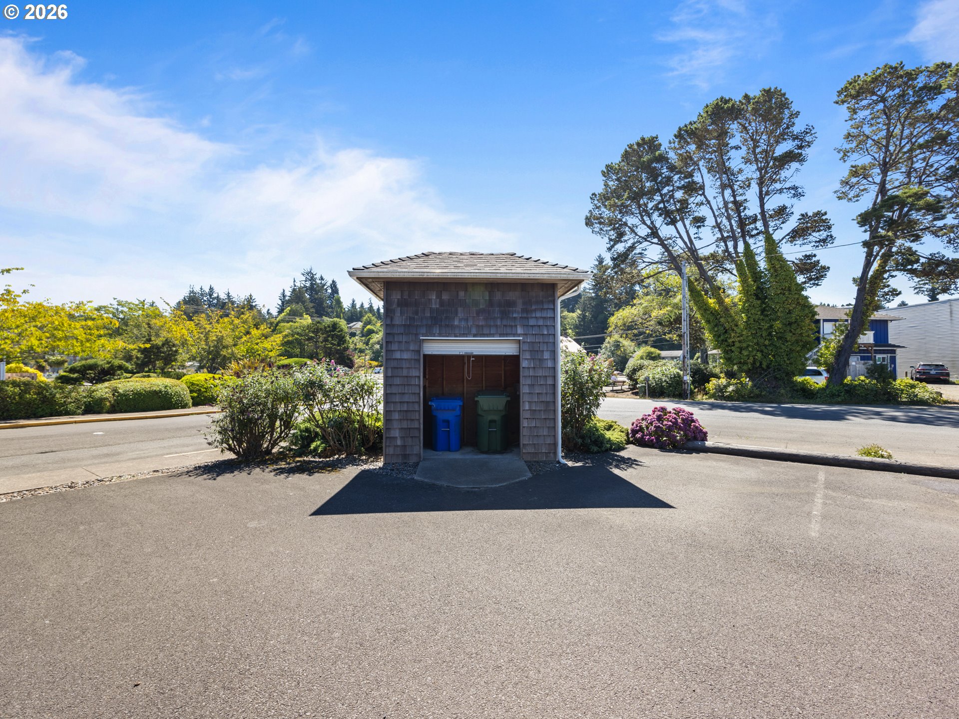 220 Northwest Spring Street Waldport, OR 97394 - Photo 16 of 16 a front view of a house with a garden and trees