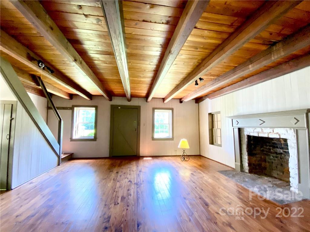 9425 Robinson Church Road Charlotte, NC 28215 - Photo 16 of 34 a view of an empty room with exposed radiator and fireplace