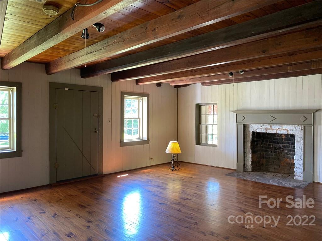 9425 Robinson Church Road Charlotte, NC 28215 - Photo 17 of 34 a view of an empty room with wooden floor and a window
