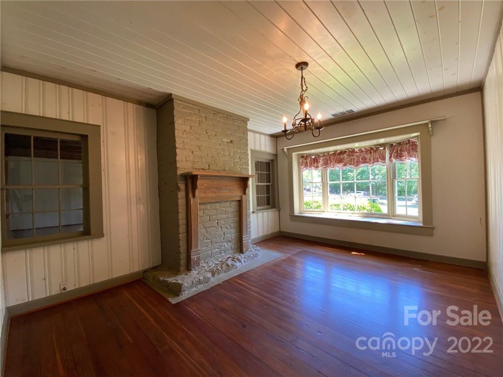 9425 Robinson Church Road Charlotte, NC 28215 - Photo 20 of 34 a view of an empty room with wooden floor fireplace and a window