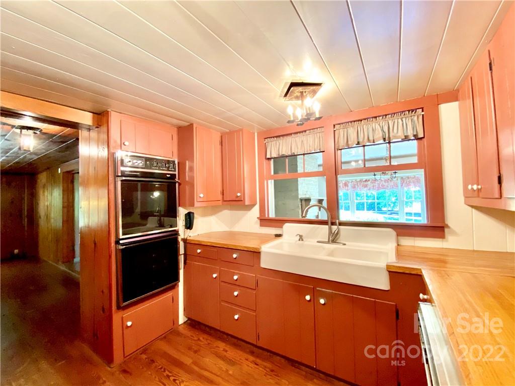 9425 Robinson Church Road Charlotte, NC 28215 - Photo 22 of 34 a kitchen with stainless steel appliances granite countertop a sink stove and refrigerator