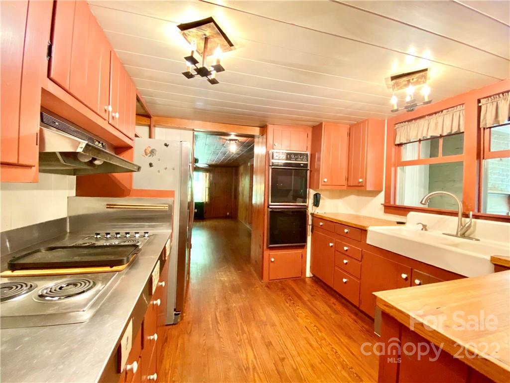 9425 Robinson Church Road Charlotte, NC 28215 - Photo 23 of 34 a kitchen with stainless steel appliances granite countertop a stove a sink and a refrigerator