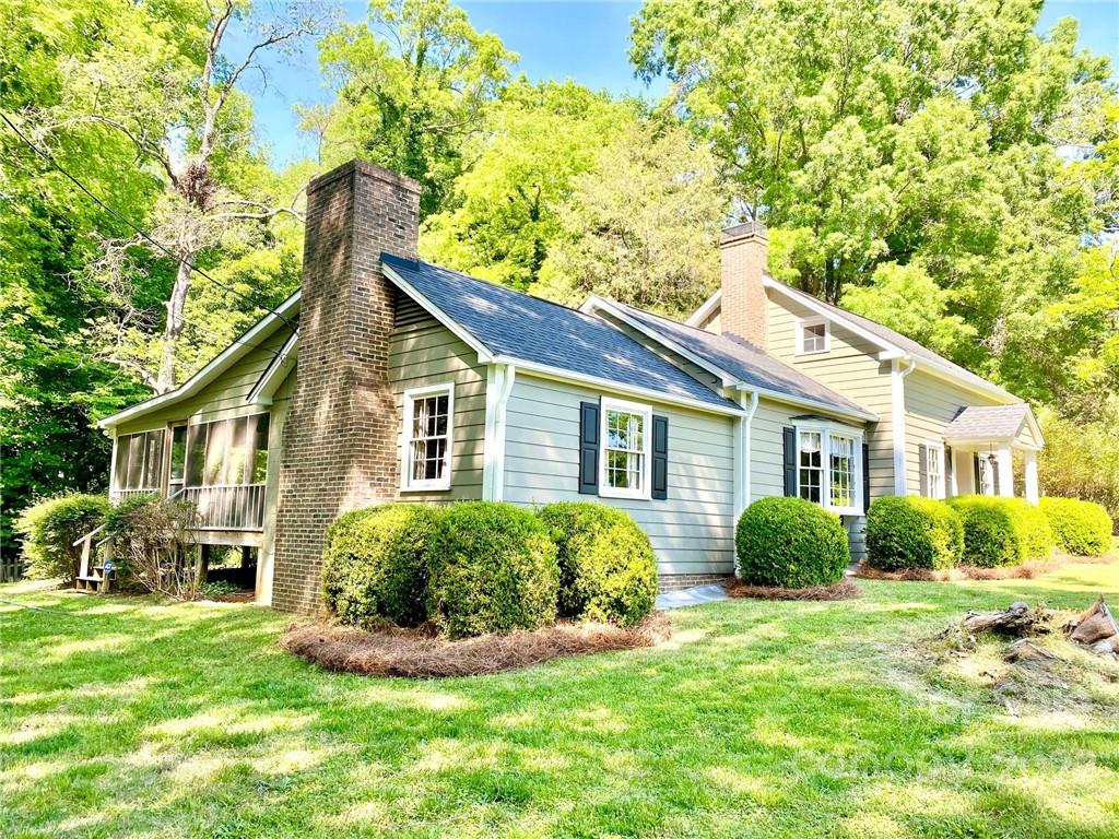 9425 Robinson Church Road Charlotte, NC 28215 - Photo 6 of 34 a view of a house with a yard and potted plants